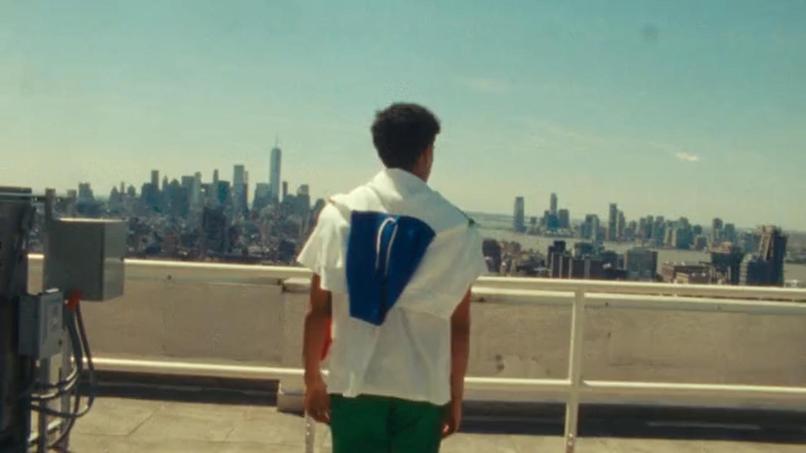 a man standing on top of a roof with a cell phone