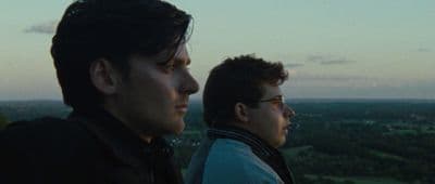 a couple of men standing next to each other