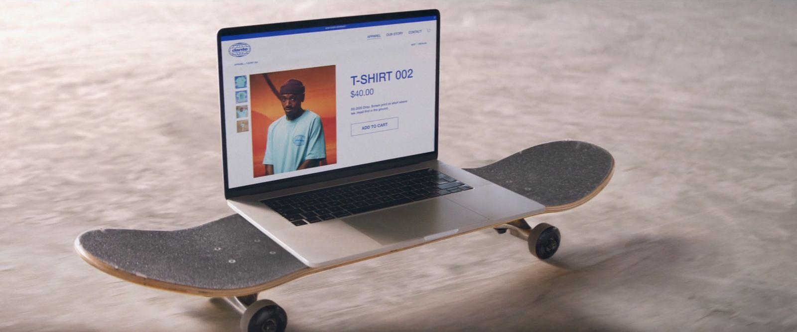 a laptop computer sitting on top of a skateboard