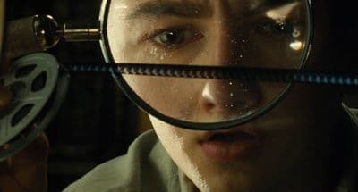 a man looking through a magnifying glass