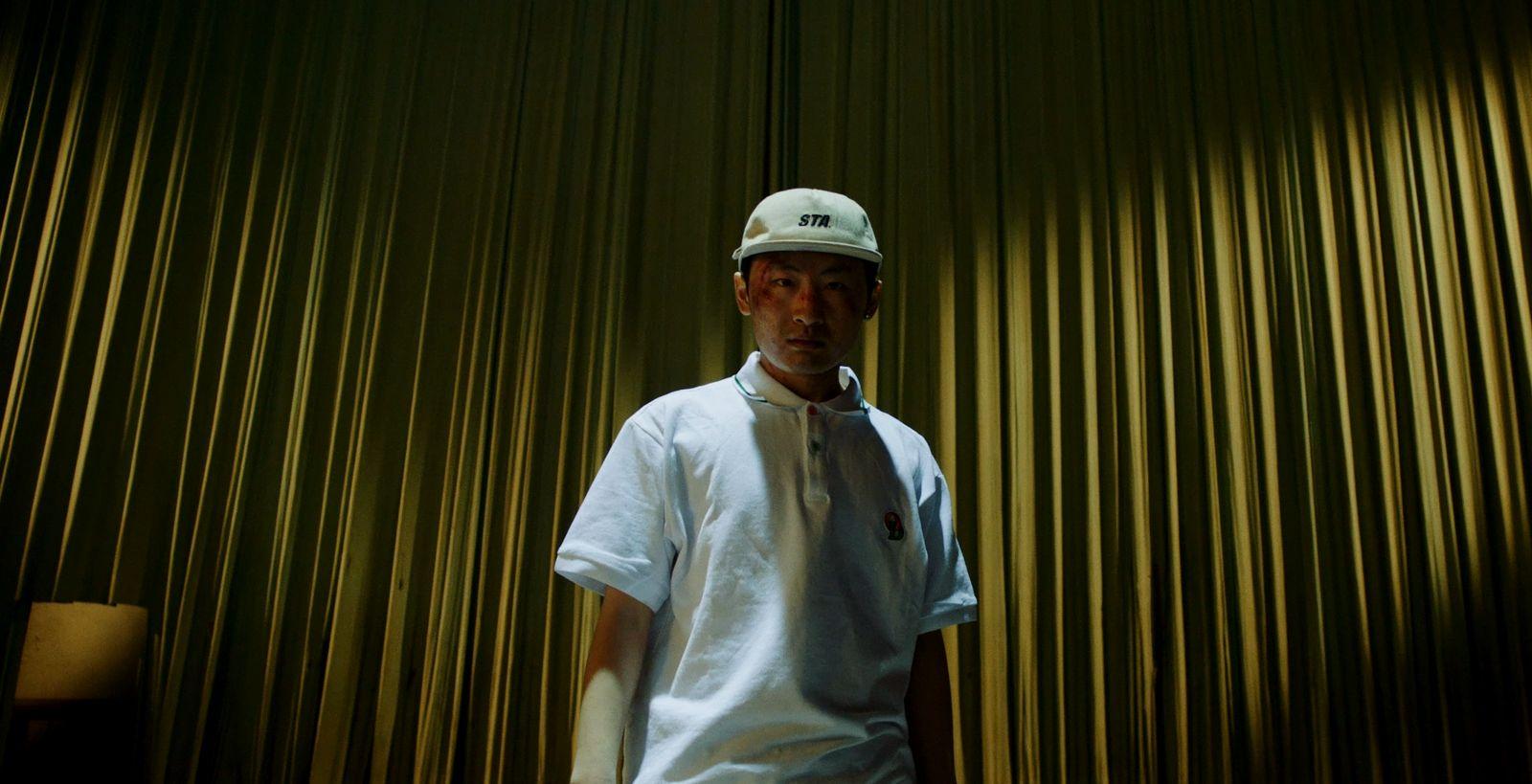a man standing in front of a curtain