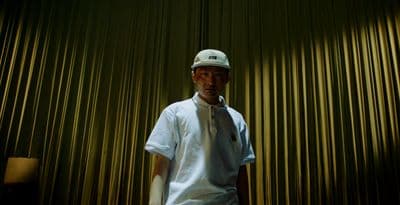a man standing in front of a curtain