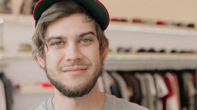 a man with a beard wearing a hat