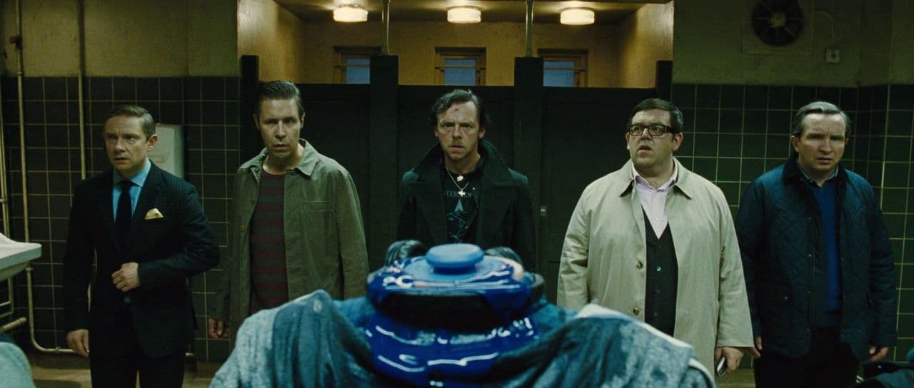 a group of men standing next to each other in a bathroom