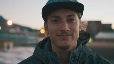 a man in a green jacket and a black hat