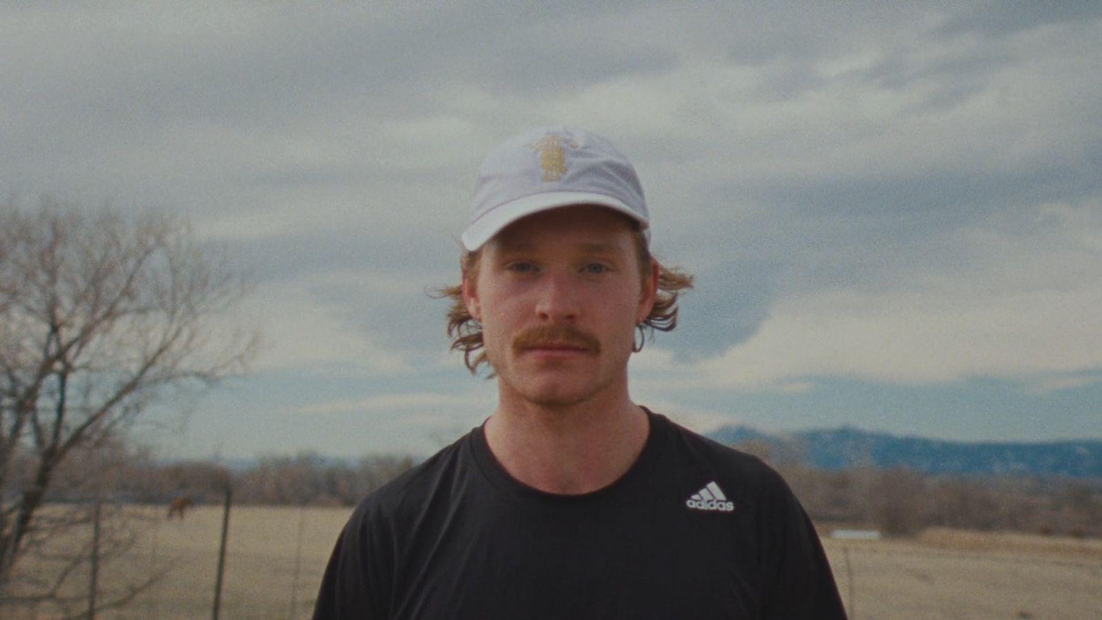 a man in a black shirt and a hat