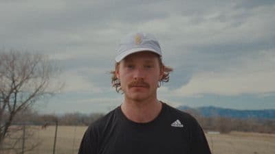 a man in a black shirt and a hat