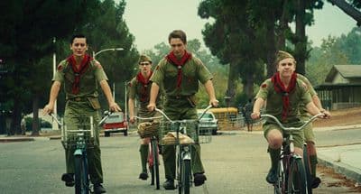 a group of men riding bikes down a street