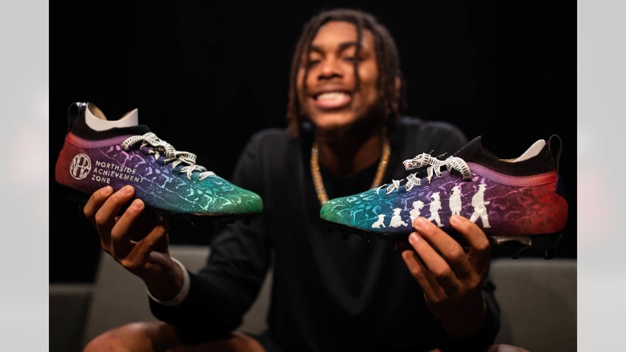 a man sitting on a couch holding a pair of shoes