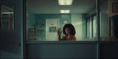 a woman is looking out of a window
