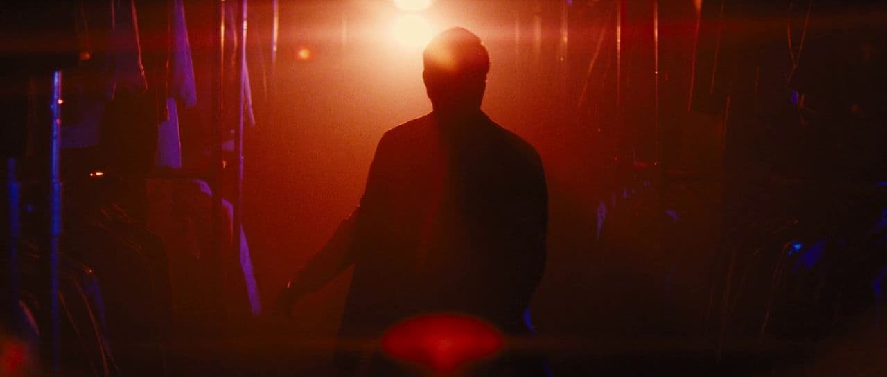 a silhouette of a person standing in a dark room