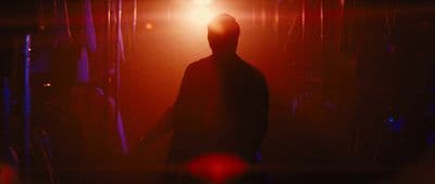 a silhouette of a person standing in a dark room