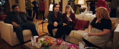 a group of people sitting around a living room together