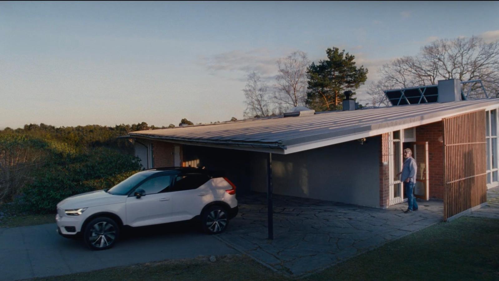 a white car parked in front of a garage