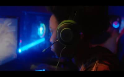 a man wearing headphones playing a video game