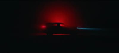 a car in the dark with a red light