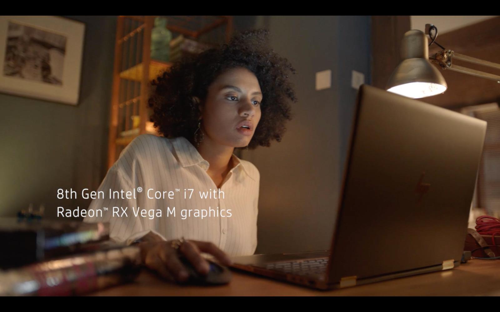 a woman sitting in front of a laptop computer