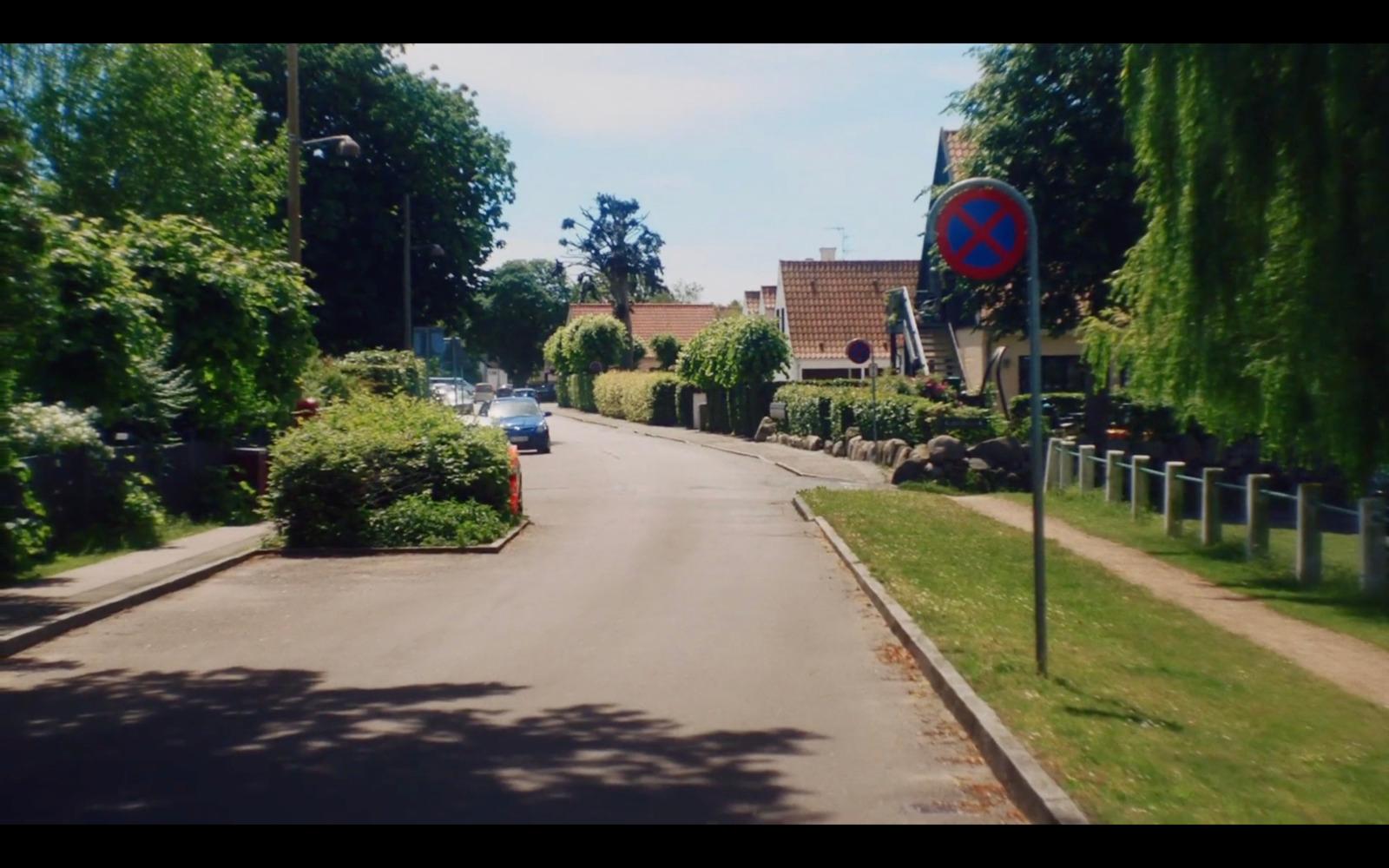 a street with cars parked on the side of it