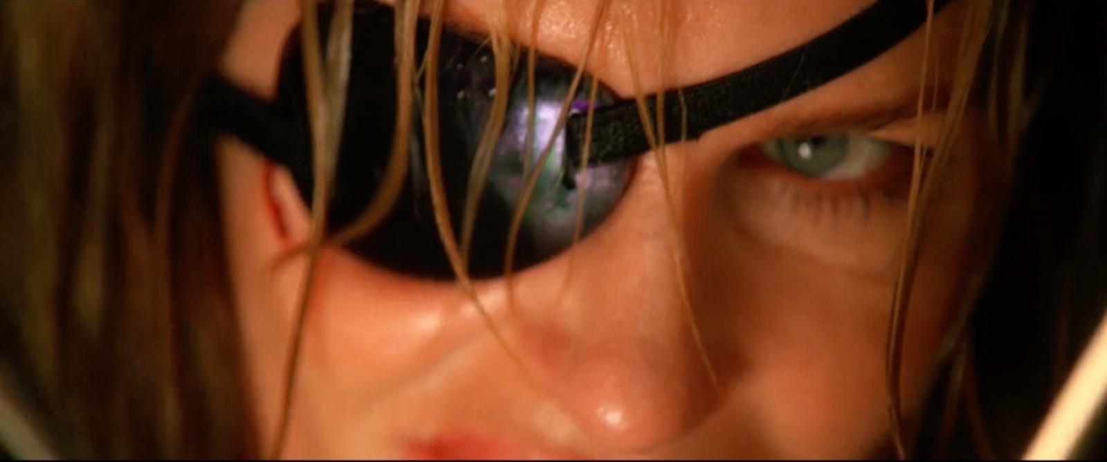 a close up of a person with a pair of scissors in their eye