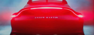 the back end of a red car with the word ashton martin on it