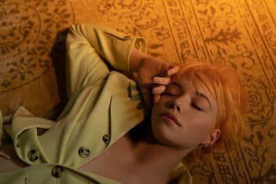 a woman laying on the floor with her eyes closed