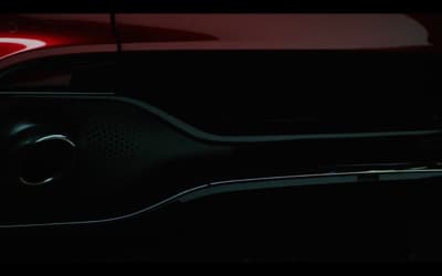 a close up of a red car in the dark
