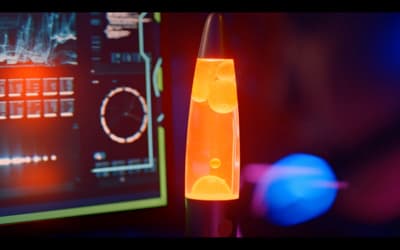 a close up of a lava lamp in front of a computer screen