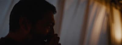 a man standing in front of a white curtain