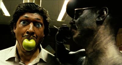 a man with an apple in his mouth