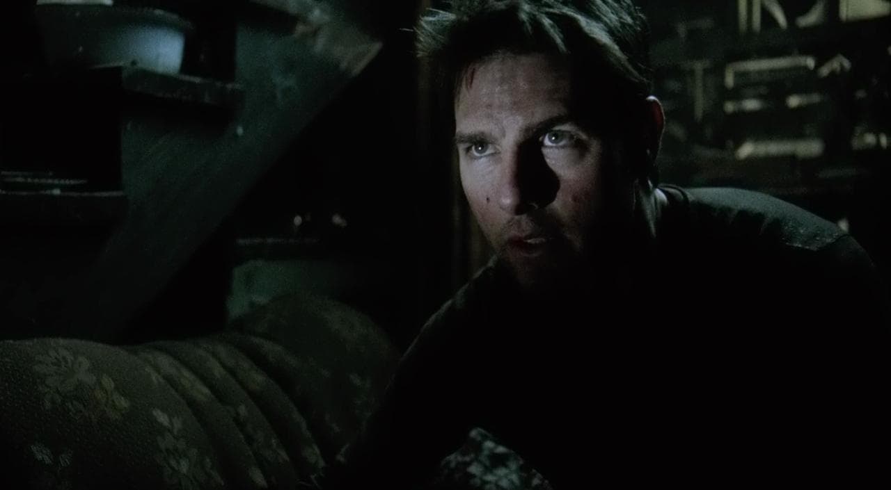 a man in a dark room staring at the camera