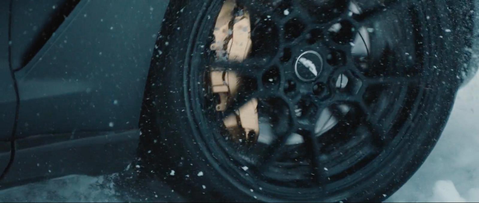 a close up of a tire on a car in the snow
