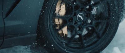 a close up of a tire on a car in the snow