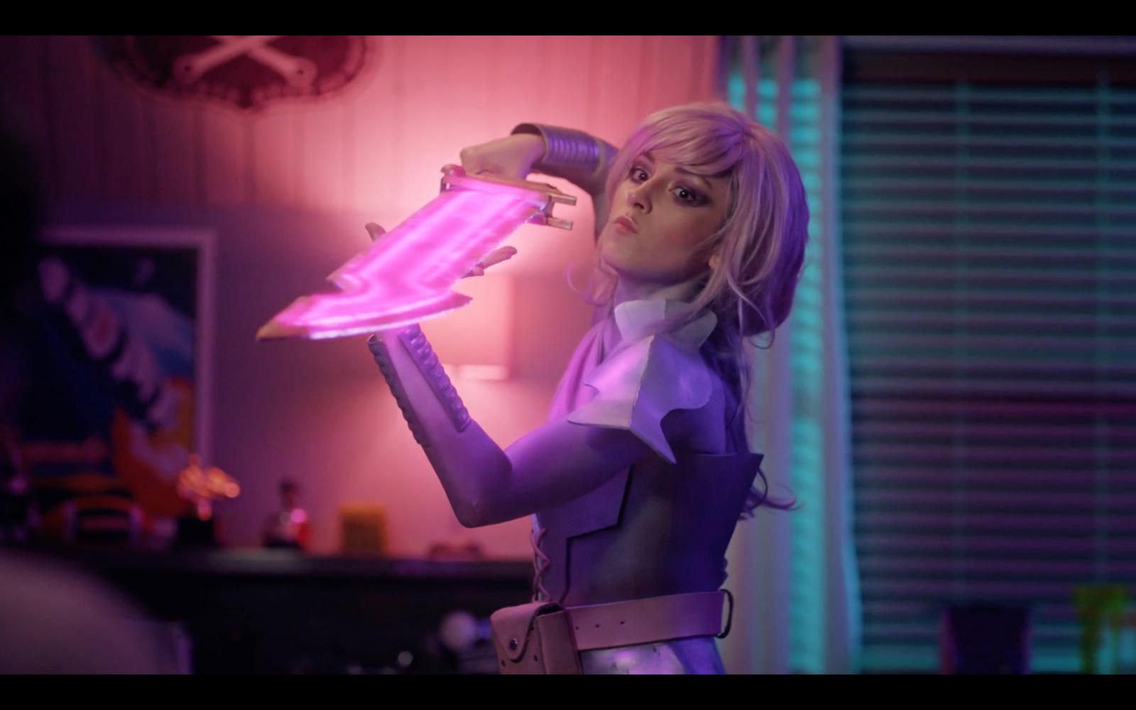 a woman in a purple outfit holding a pink light
