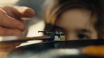 a close up of a person holding a record player