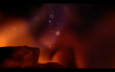 a blurry image of a candle in the dark