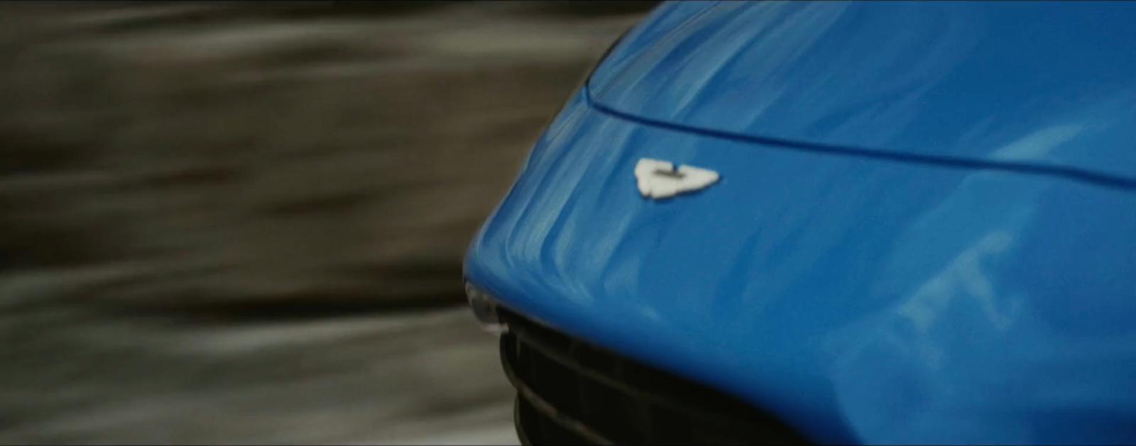 a blue car with a heart shaped sticker on it