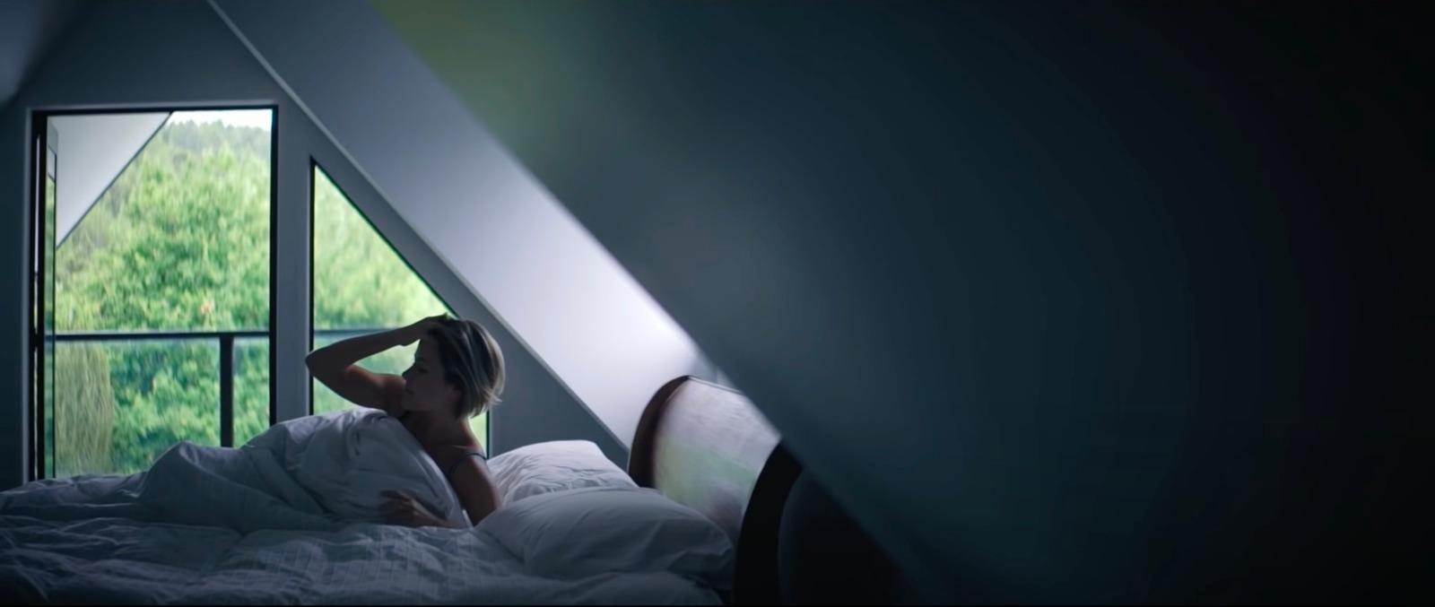 a woman laying in a bed in a room