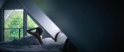 a woman laying in a bed in a room