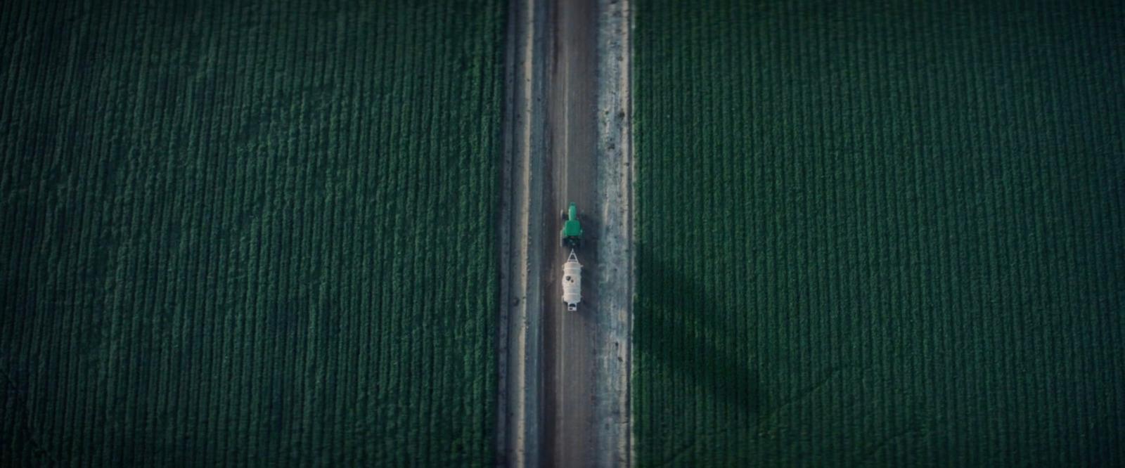 an aerial view of a car driving down a road