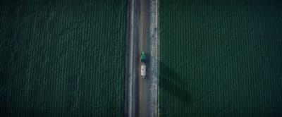 an aerial view of a car driving down a road