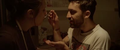 a man is feeding a woman something with a spoon