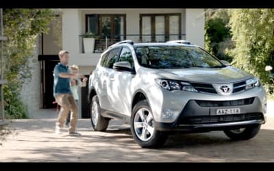 a man walking next to a white suv