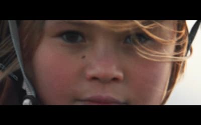 a close up of a child wearing a headset