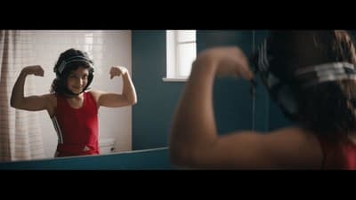 a woman in a red shirt brushing her hair