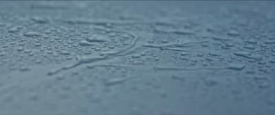 a close up of water droplets on a surface