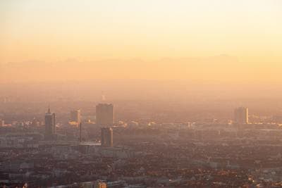 a view of a city at sunset with a hazy sky