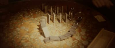 a wooden table topped with lots of coins