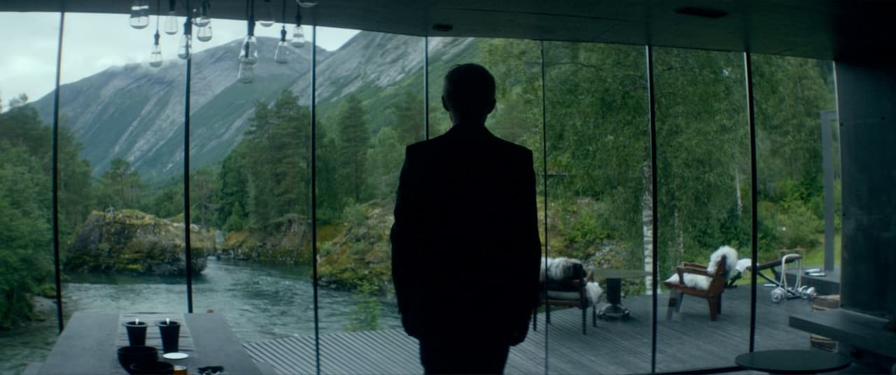 a man standing in front of a glass wall