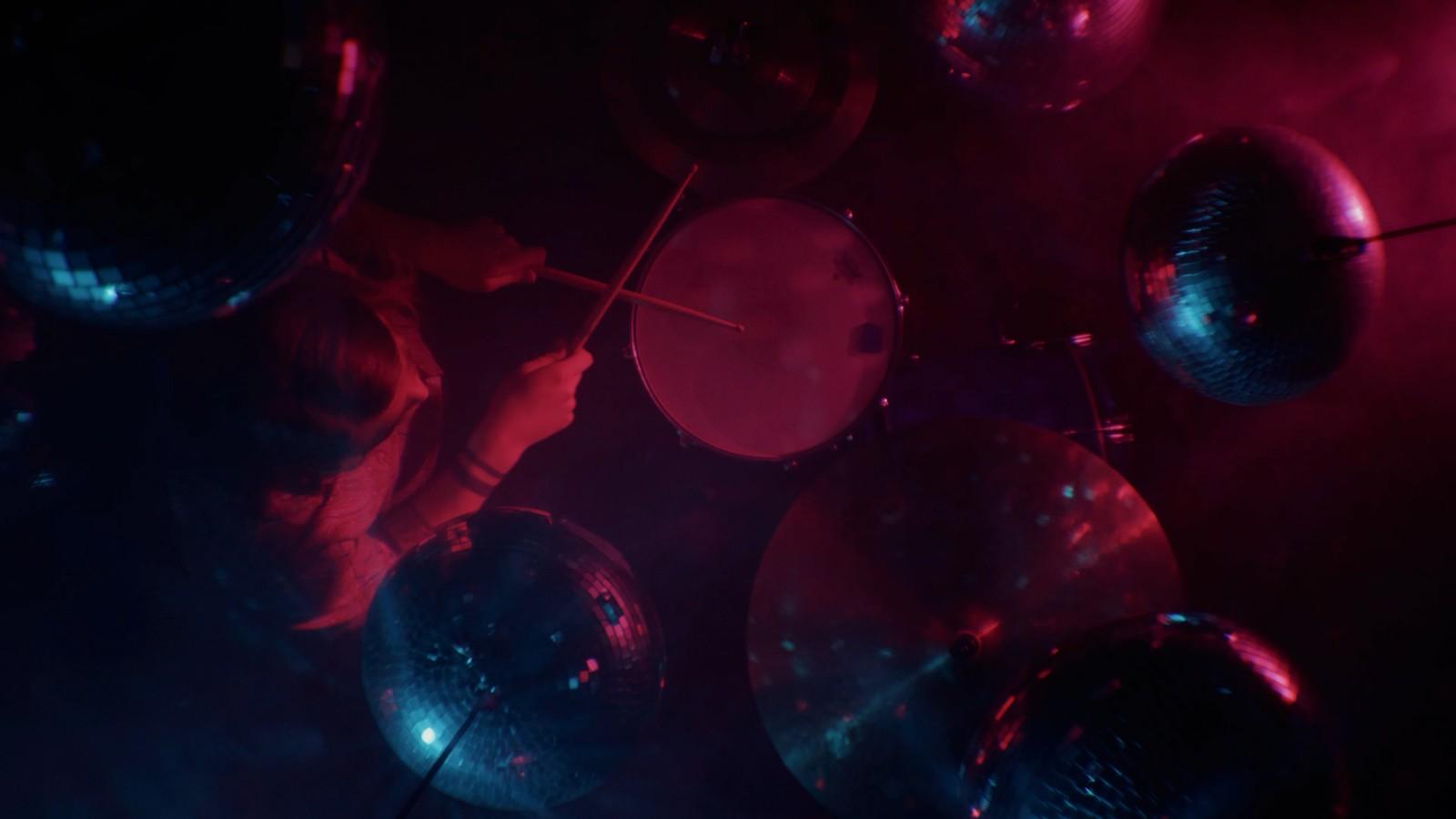 a group of shiny balls hanging from a ceiling