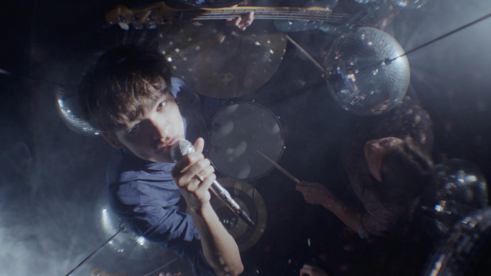 a man holding a microphone in front of a group of people